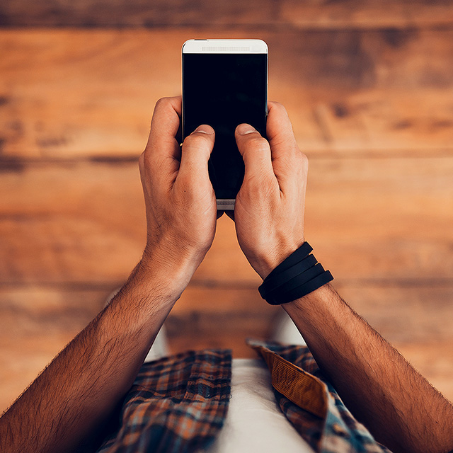 photo of a hand with an iPhone and Apple Watch