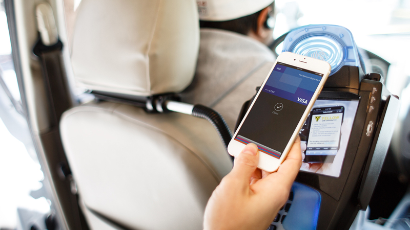 Using Apple Pay at a contactless-enabled terminal inside a taxi.