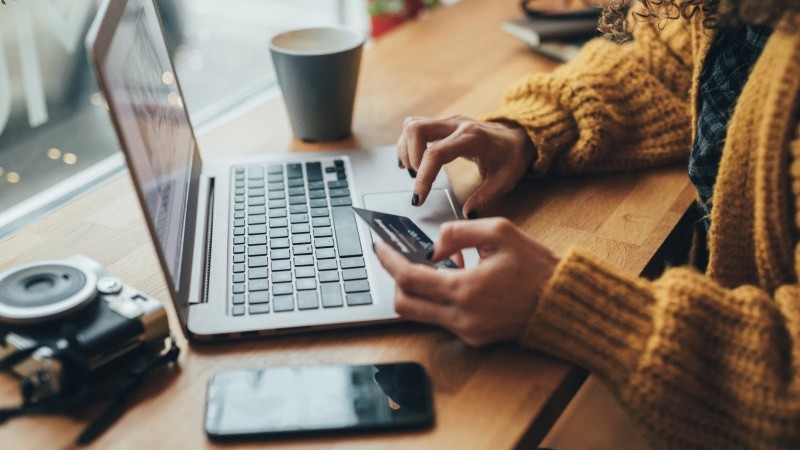 Woman typing on laptop making payment