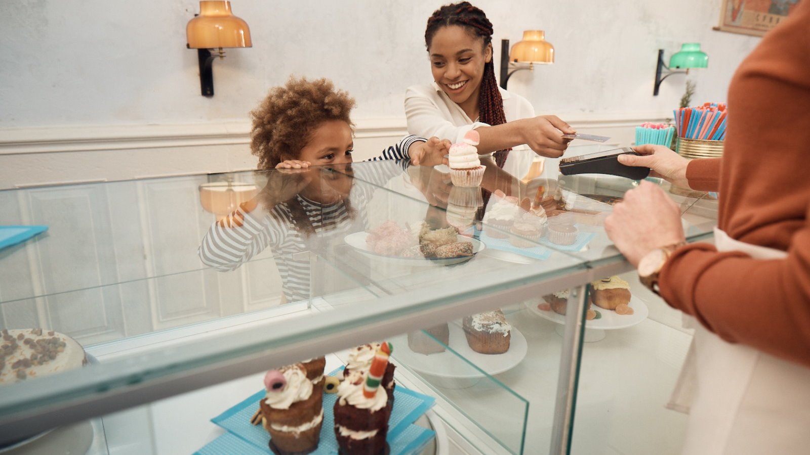 Family paying for cakes